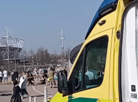 People being treated by paramedics outside the London Aquatics Centre. Credit: SWNS
