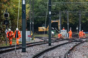 Rail workers begin recovery work on the tram rail lines junction at the site of the Croydon tram crash