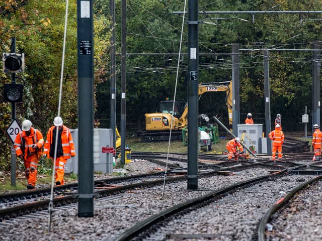 Rail workers begin recovery work on the tram rail lines junction at the site of the Croydon tram crash