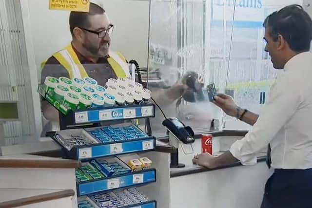 Rishi Sunak appears to try and pay for his coke by scanning his contactless card on the barcode reader. Credit: Sky News
