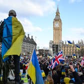 Demonstrators hold placards, Ukrainian and British flags during a protest rally in London in support of Ukraine. Photo: Getty