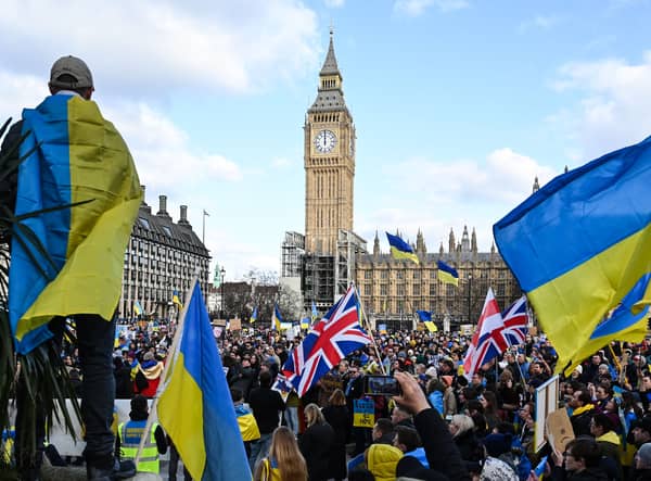 Demonstrators hold placards, Ukrainian and British flags during a protest rally in London in support of Ukraine. Photo: Getty