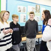 (Left to right) Mum Oksana Kyrychenko, Roman Kyrychenko, 12, Vlad Kyrychenko, 14, deputy head Amy Brown and history teacher Nicholas Penn. Credit: Ben Mole / SWNS