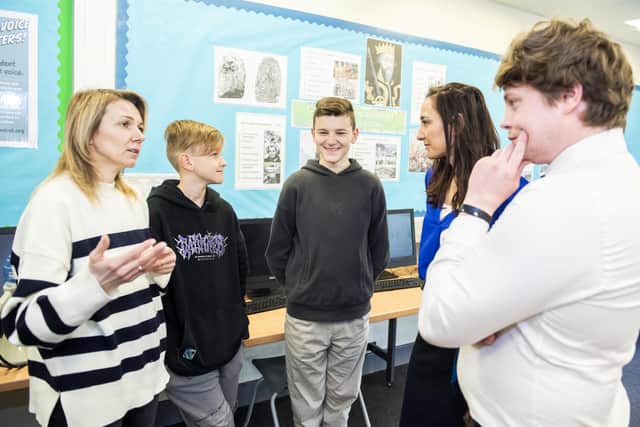 (Left to right) Mum Oksana Kyrychenko, Roman Kyrychenko, 12, Vlad Kyrychenko, 14, deputy head Amy Brown and history teacher Nicholas Penn. Credit: Ben Mole / SWNS