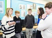 (Left to right) Mum Oksana Kyrychenko, Roman Kyrychenko, 12, Vlad Kyrychenko, 14, deputy head Amy Brown and history teacher Nicholas Penn. Credit: Ben Mole / SWNS