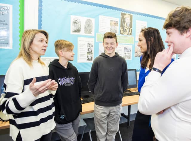 (Left to right) Mum Oksana Kyrychenko, Roman Kyrychenko, 12, Vlad Kyrychenko, 14, deputy head Amy Brown and history teacher Nicholas Penn. Credit: Ben Mole / SWNS