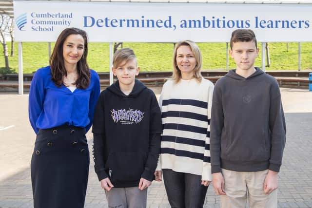 Amy Brown, deputy head, Roman Kyrychenko, 12, Oksana Kyrychenko, mum, and Vlad Kyrychenko,14. Credit: Ben Mole / SWNS