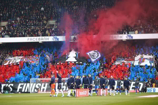 Crystal Palace fans raise a banner with an image of the FA Cup trophy  (Photo by Christopher Lee/Getty Images)