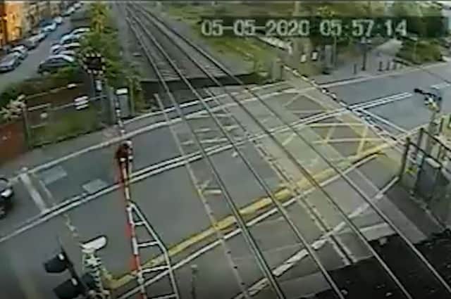 The man jumping the crossing with no train in sight. Credit: SWNS