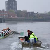 The Cambridge University men's boat are trailed by their coach as they train early in the morning on the River Thames in London on March 30, 2022, 