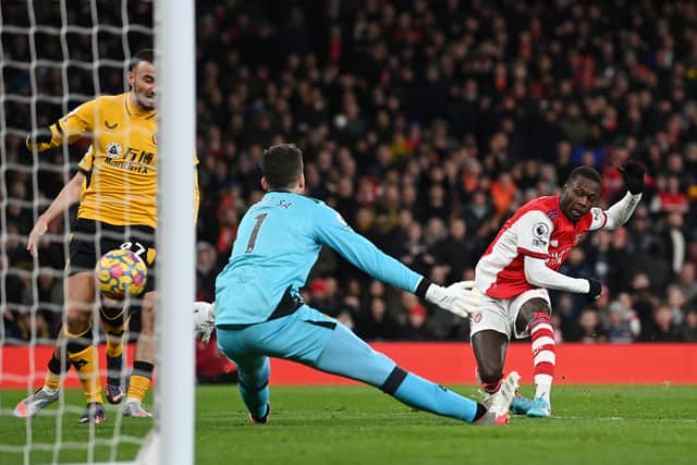Nicolas Pepe of Arsenal scores their sides first goal past Jose Sa of Wolverhampton Wanderers (Photo by Shaun Botterill/Getty Images)