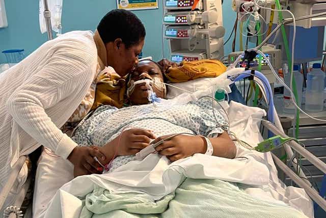 Mum Wumi kisses Damilola Olakanmi goodbye in hospital, after she fell ill from eating what she thought was a cannabis sweet. Credit: Family handout
