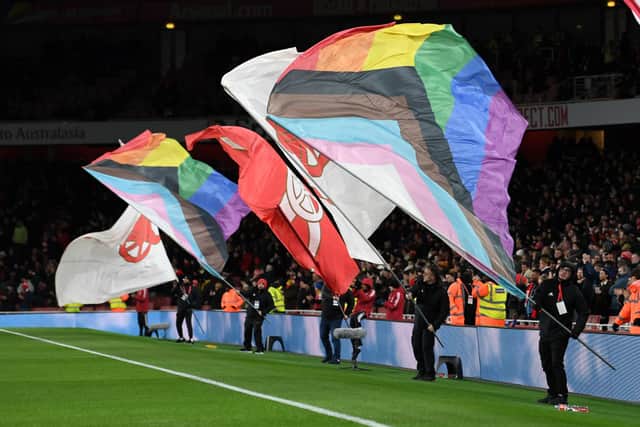 The rainbow flag is waved before the Premier League match between Arsenal and Wolverhampton Wanderers at Emirates Stadium. Credit: David Price/Arsenal FC via Getty Images