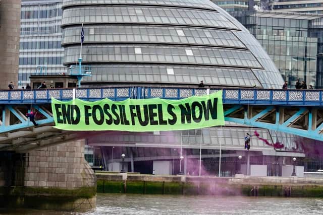Extinction Rebellion drop huge banner off Tower Bridge on eve of Rebellion in London