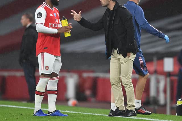 Arsenal Head Coach Mikel Arteta speaks to Alex Lacazette during the Premier League match (Photo by Stuart MacFarlane/Arsenal FC via Getty Images)