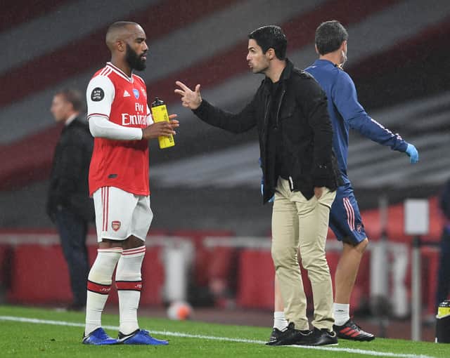 Arsenal Head Coach Mikel Arteta speaks to Alex Lacazette during the Premier League match (Photo by Stuart MacFarlane/Arsenal FC via Getty Images)