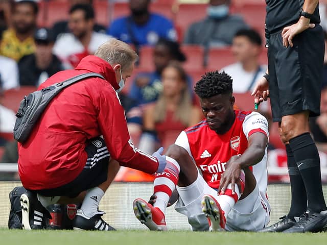Thomas Partey receives treatment for an injury during the pre-season friendly football match  (Photo by ADRIAN DENNIS/AFP via Getty Images)