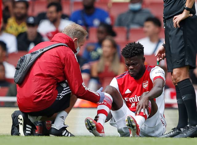 Thomas Partey receives treatment for an injury during the pre-season friendly football match  (Photo by ADRIAN DENNIS/AFP via Getty Images)