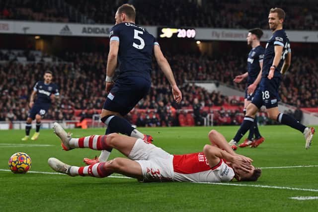 Kieran Tierney lies injured after clashing with West Ham United’s Czech defender Vladimir Coufal (Photo by BEN STANSALL/AFP via Getty Images)