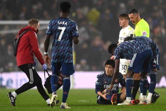  Takehiro Tomiyasu of Arsenal goes down injured during the Premier League match (Photo by Stu Forster/Getty Images)