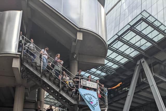 Extinction Rebellion activists hung a blue banner on the side of the Lloyd’s building saying “End Fossil Fuels Now” and drummed on the steps.