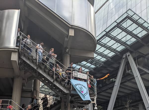 Extinction Rebellion activists hung a blue banner on the side of the Lloyd’s building saying “End Fossil Fuels Now” and drummed on the steps.