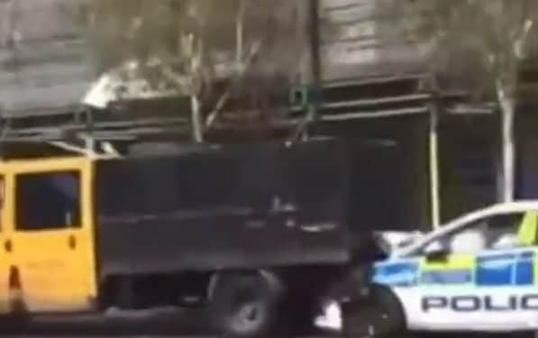 The tipper truck smashing into the police car in Brixton. Credit: UB1UB2