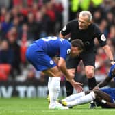 An injured Antonio Ruediger of Chelsea is spoken to by Cesar Azpilicueta and referee Martin Atkinson  (Photo by Shaun Botterill/Getty Images)