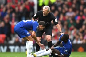 An injured Antonio Ruediger of Chelsea is spoken to by Cesar Azpilicueta and referee Martin Atkinson  (Photo by Shaun Botterill/Getty Images)