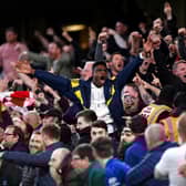 Arsenal fans celebrate their sides second goal during the Premier League match Photo by Justin Setterfield/Getty Images)