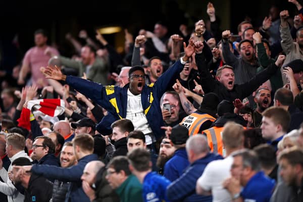 Arsenal fans celebrate their sides second goal during the Premier League match Photo by Justin Setterfield/Getty Images)