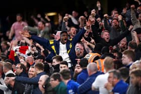 Arsenal fans celebrate their sides second goal during the Premier League match Photo by Justin Setterfield/Getty Images)