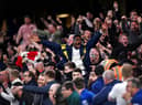 Arsenal fans celebrate their sides second goal during the Premier League match Photo by Justin Setterfield/Getty Images)
