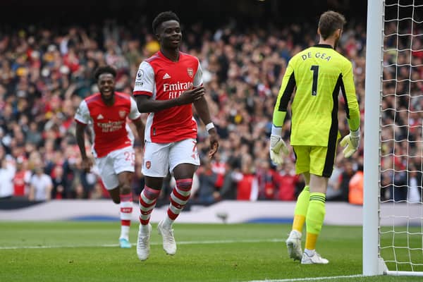Bukayo Saka of Arsenal celebrates after scoring their side's second goal during the Premier League match (Photo by Mike Hewitt/Getty Images)