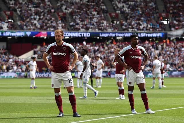 Craig Dawson and Ben Johnson of West Ham United react after play is stopped due to a crowd incident (Photo by Ryan Pierse/Getty Images)
