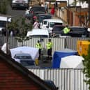 Police and forensic officers, along with police tents at the scene. (Photo by Hollie Adams/Getty Images)