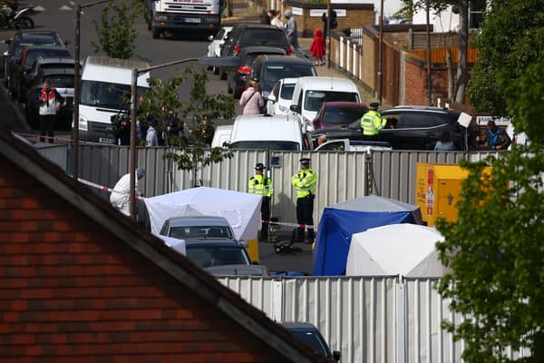 Police and forensic officers, along with police tents at the scene. (Photo by Hollie Adams/Getty Images)