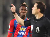  Wilfried Zaha of Crystal Palace looks on as match referee Darren England gestures during the Premier  (Photo by Warren Little/Getty Images)