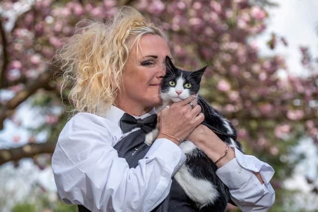 The five-year-old cat, who was draped in gold lame for the special day, meowed her way through her vows as Deborah’s friends watched on in a park in south-east London. Credit: James Linsell-Clark / SWNS