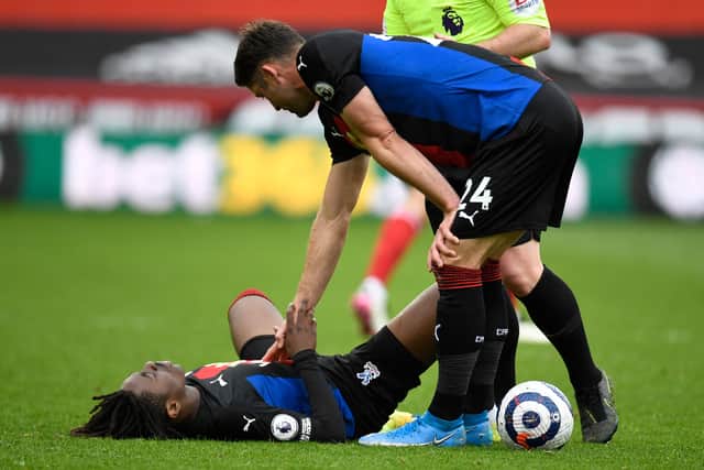 Crystal Palace’s English defender Gary Cahill (R) gives Crystal Palace’s English midfielder Eberechi Eze a hand up during the English Premier  (Photo by PETER POWELL/POOL/AFP via Getty Images)