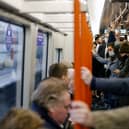 Commuters on the London Overground. Credit: TOLGA AKMEN/AFP via Getty Images