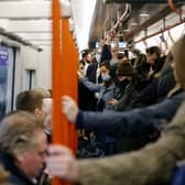 Commuters on the London Overground. Credit: TOLGA AKMEN/AFP via Getty Images