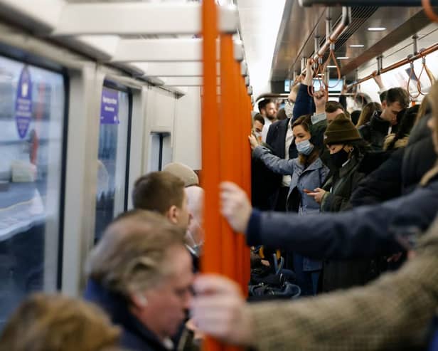 Commuters on the London Overground. Credit: TOLGA AKMEN/AFP via Getty Images