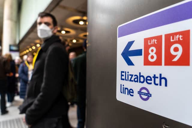 Volunteer ‘passengers’ walk on the platform during a test run of a Transport for London (TfL) Elizabeth Line train between Paddington station and Woolwich station and back, at Paddington Station in London . (Photo by NIKLAS HALLE’N/AFP via Getty Images)