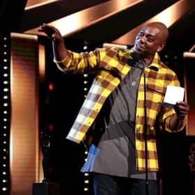  Dave Chappelle speaks onstage during the 36th Annual Rock & Roll Hall Of Fame Induction Ceremony at Rocket Mortgage Fieldhouse on October 30, 2021 in Cleveland, Ohio (Photo by Dimitrios Kambouris/Getty Images for The Rock and Roll Hall of Fame )