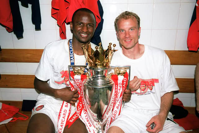 Patrick Vieira and Dennis Bergkamp of Arsenal with the Premier League Trophy (Photo by Stuart MacFarlane/Arsenal FC via Getty Images)