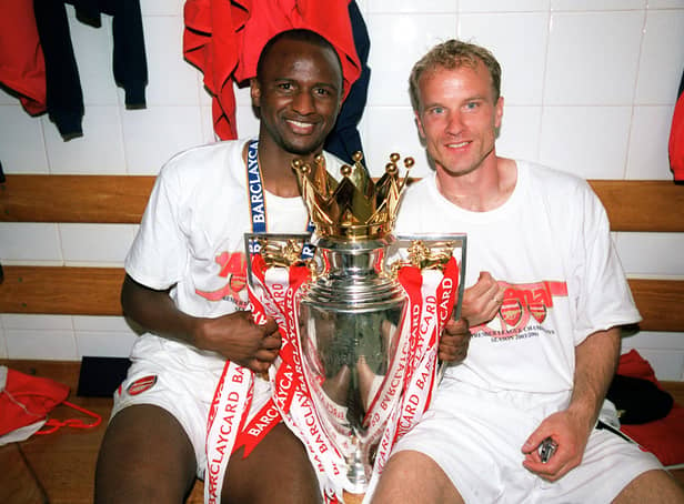 Patrick Vieira and Dennis Bergkamp of Arsenal with the Premier League Trophy (Photo by Stuart MacFarlane/Arsenal FC via Getty Images)