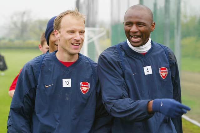 Dennis Bergkamp and Patrick Vieira of Arsenal share a joke during the Arsenal Football Club training session at London Colney training ground on April 30, 2004 in London.  (Photo by Paul Gilham/Getty Images)
