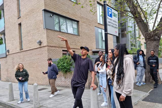 Kye Whyte looking at his mural for the first time in Peckham. Credit: LW