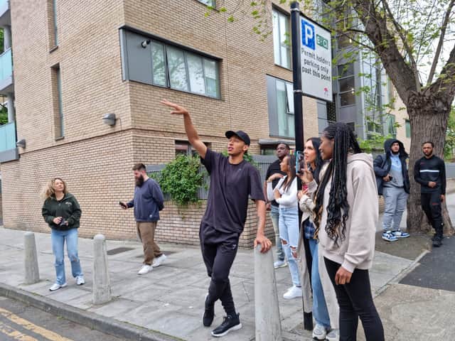Kye Whyte looking at his mural for the first time in Peckham. Credit: LW